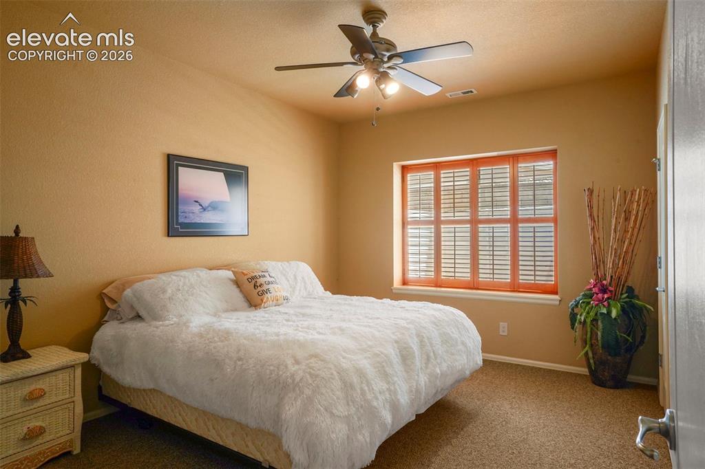Image 28 of 36: Bedroom #2 with walk-in closet, ceiling fan and garden level window