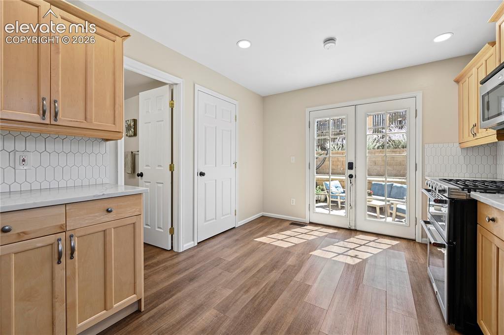 Image 11 of 48: Kitchen looking toward the doors to the backyard