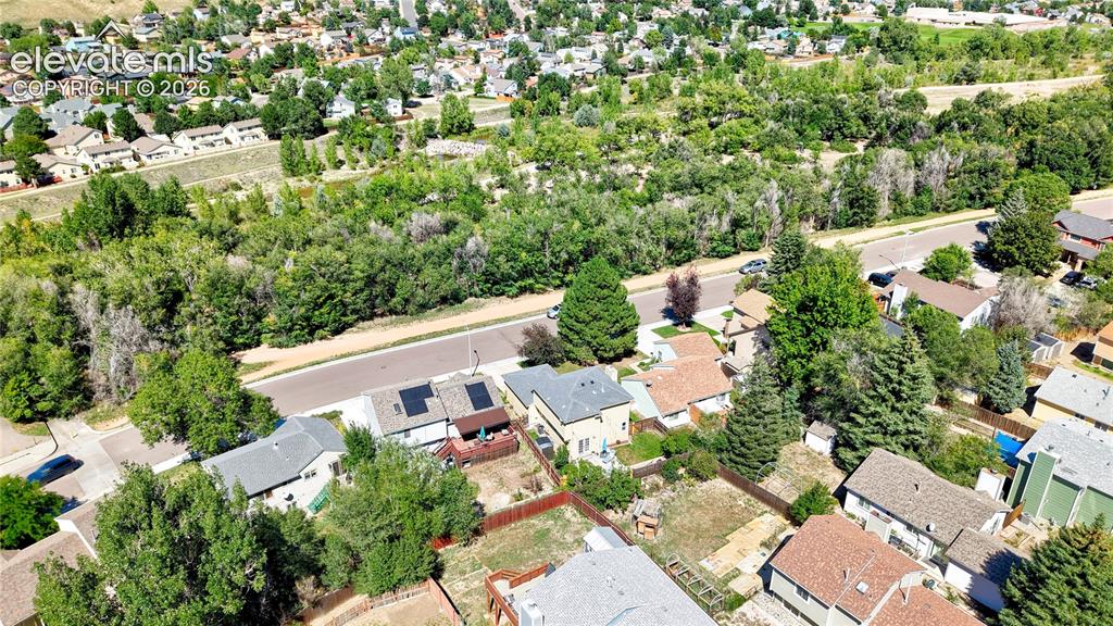 Image 36 of 48: Aerial View of the back of the home across from trail and Cottonwood Creek 