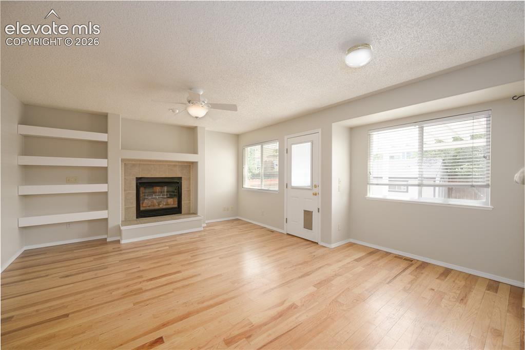 Image 6 of 36: Family room w/ built ins and a gas fireplace