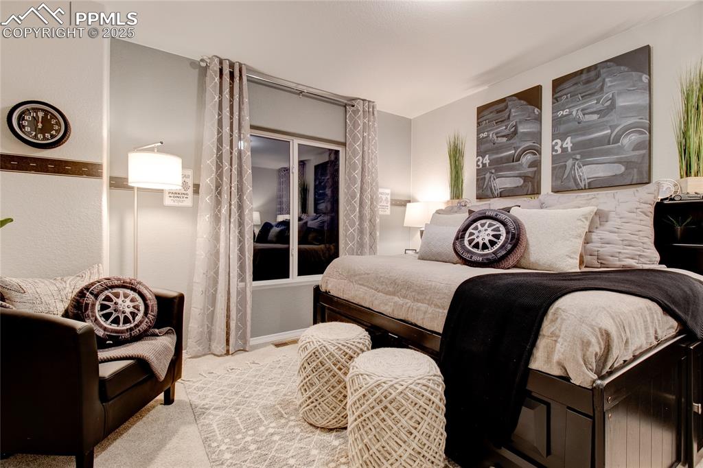 Image 26 of 28: Bedroom with carpet flooring and baseboards