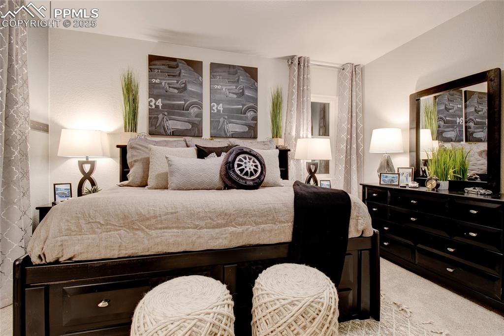 Image 27 of 28: Bedroom featuring light colored carpet