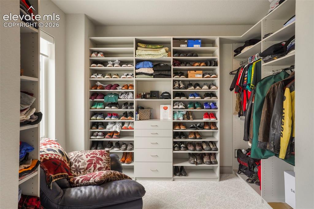 Image 18 of 31: Custom closet system featuring extensive shelving, integrated drawer units,