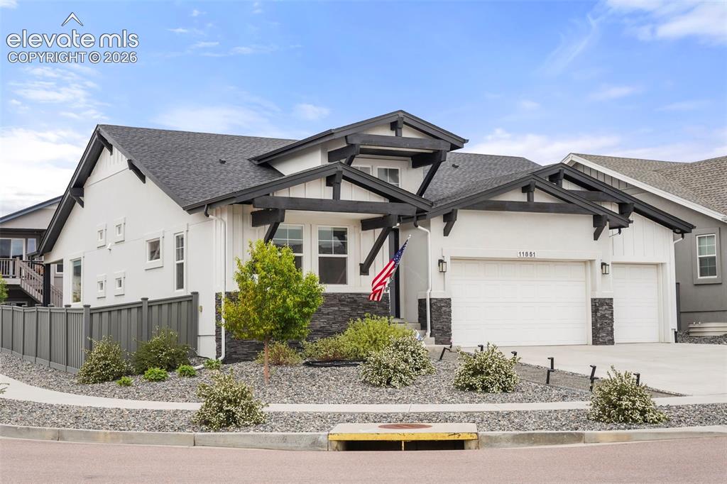 Image 2 of 31: Contemporary ranch-style residence featuring a prominent two-car garage, wh