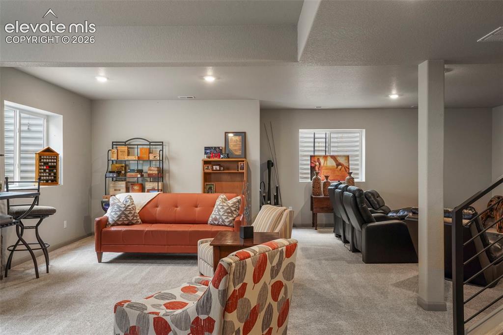 Image 23 of 31: Spacious lower-level area featuring recessed lighting, light gray carpeting
