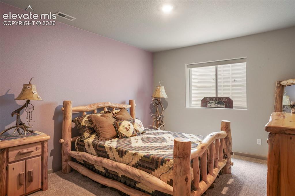 Image 28 of 31: Bedroom featuring soft purple and gray wall tones