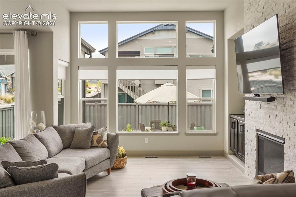 Image 7 of 31: Living area featuring a floor-to-ceiling window arrangement with multiple p