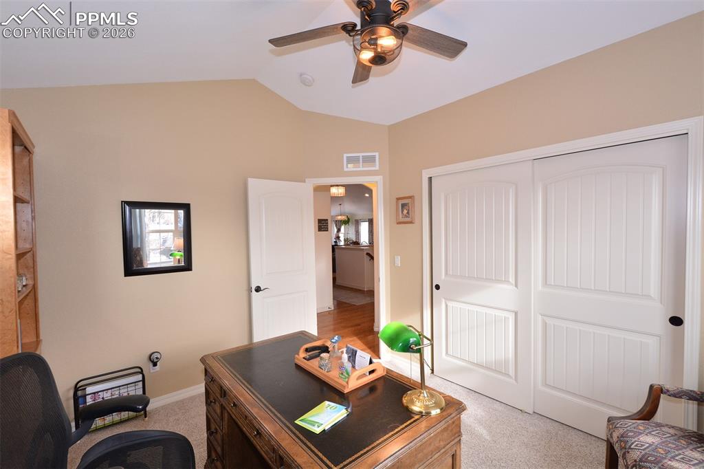 Image 17 of 43: Bedroom on main level, currently being used as an office