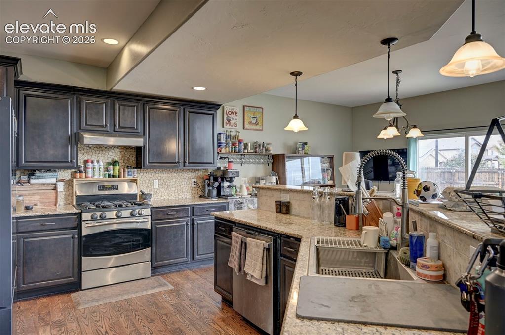 Image 10 of 49: Kitchen: gas range, double oven and stainless appliances