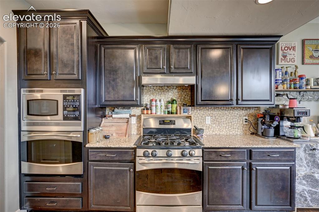 Image 11 of 49: Kitchen with double oven and gas range