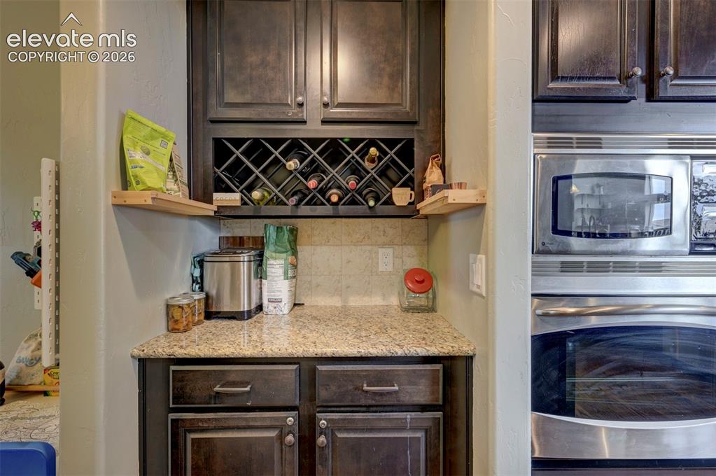 Image 15 of 49: Dry bar with wine storage