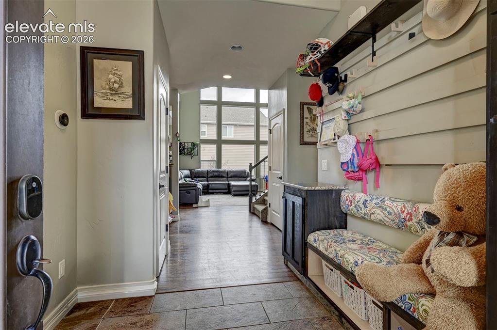 Image 18 of 49: Mudroom bench off the garage