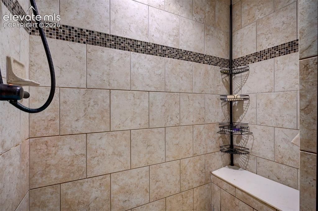 Image 30 of 49: Primary bath tiled shower