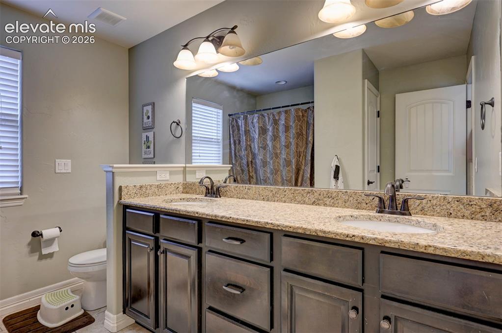 Image 34 of 49: Upstairs hall bath with double vanity