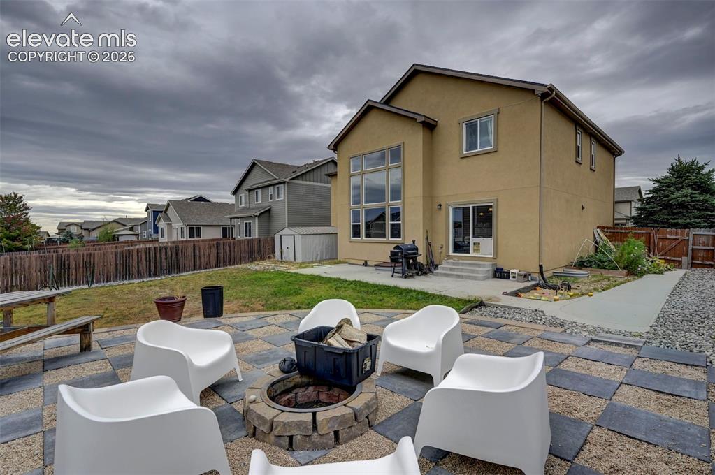 Image 40 of 49: Fire pit on the paver patio