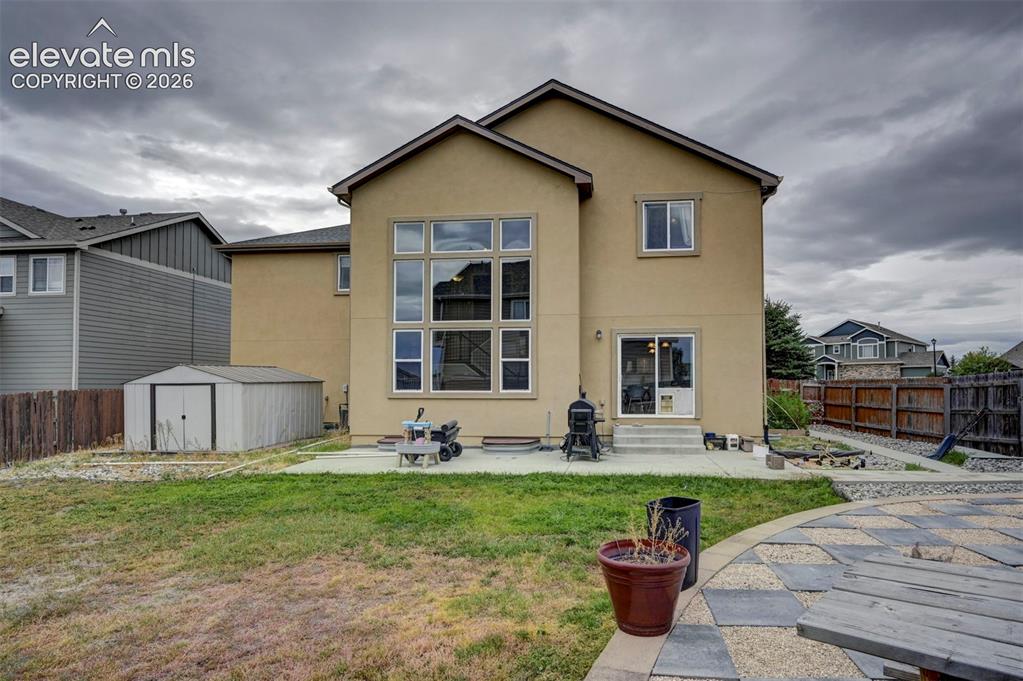 Image 42 of 49: Back of the home and storage shed