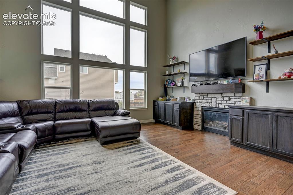 Image 7 of 49: Gas fireplace with stone surround