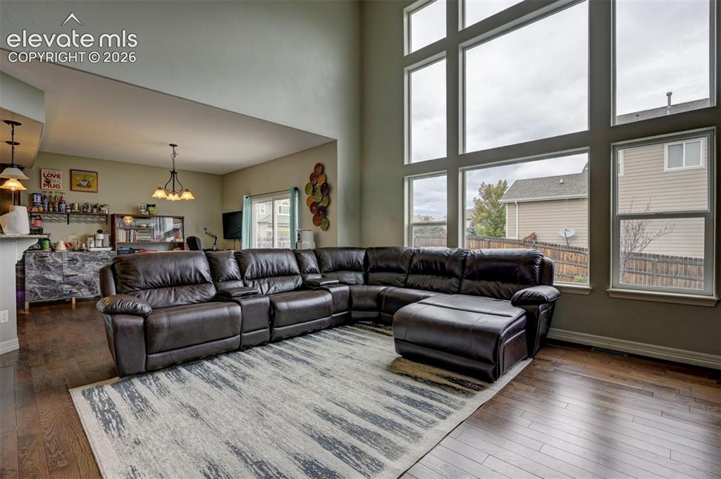 Image 8 of 49: Great room with a wall of windows, open to the kitchen