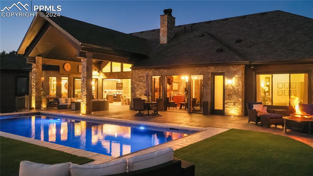 Image 40 of 50: Stamped concrete patio, pool, artificial turf, lots of seating areas.