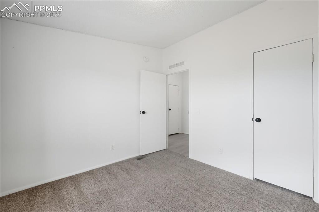 Image 28 of 45: Unfurnished bedroom featuring carpet flooring and baseboards