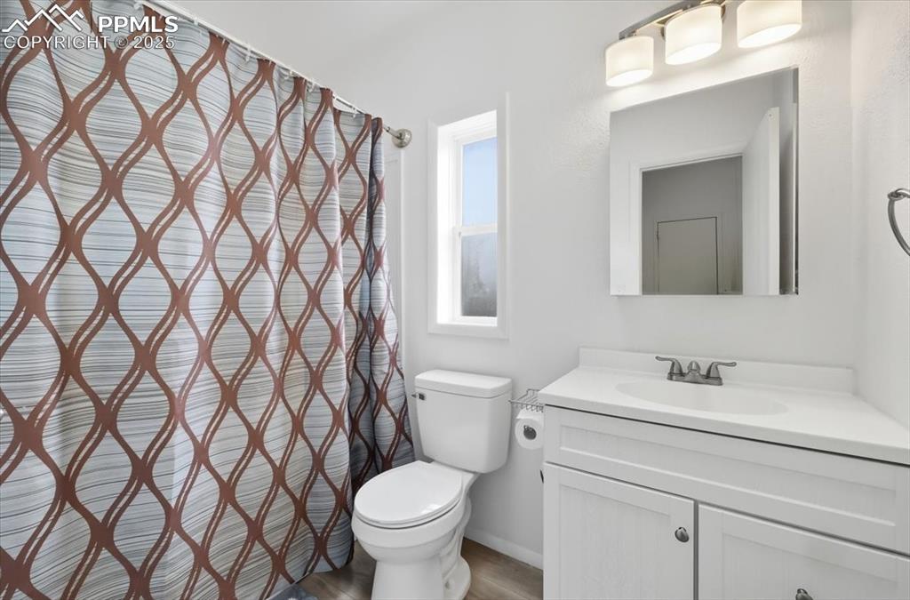 Image 29 of 45: Full bath featuring vanity and a shower with curtain