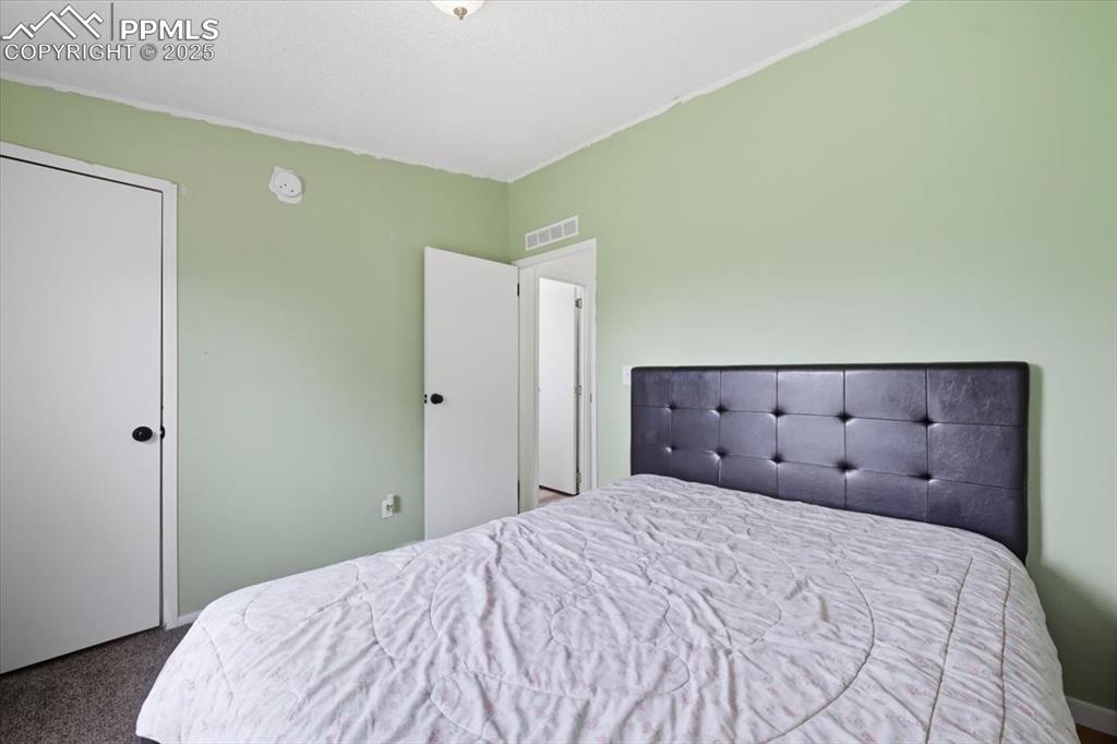 Image 31 of 45: Bedroom with carpet floors and baseboards