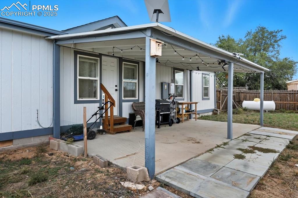 Image 41 of 45: Rear view of house with a patio area