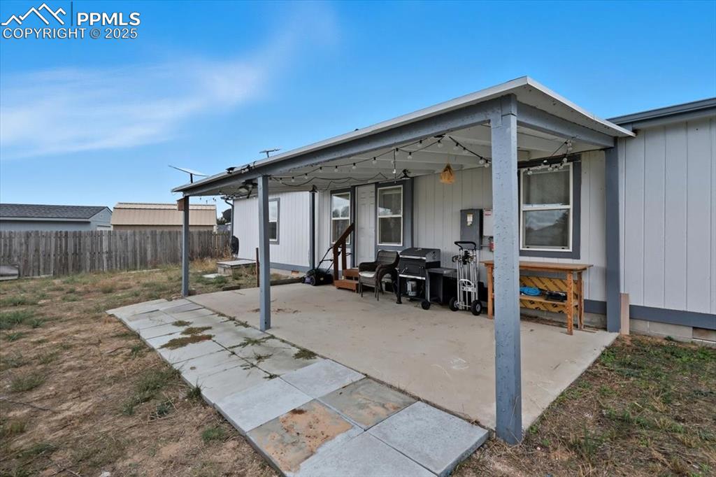 Image 42 of 45: View of patio with a grill