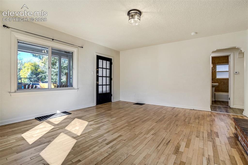 Image 10 of 50: Interior space featuring wood-finish flooring, a multi-pane glass door, and