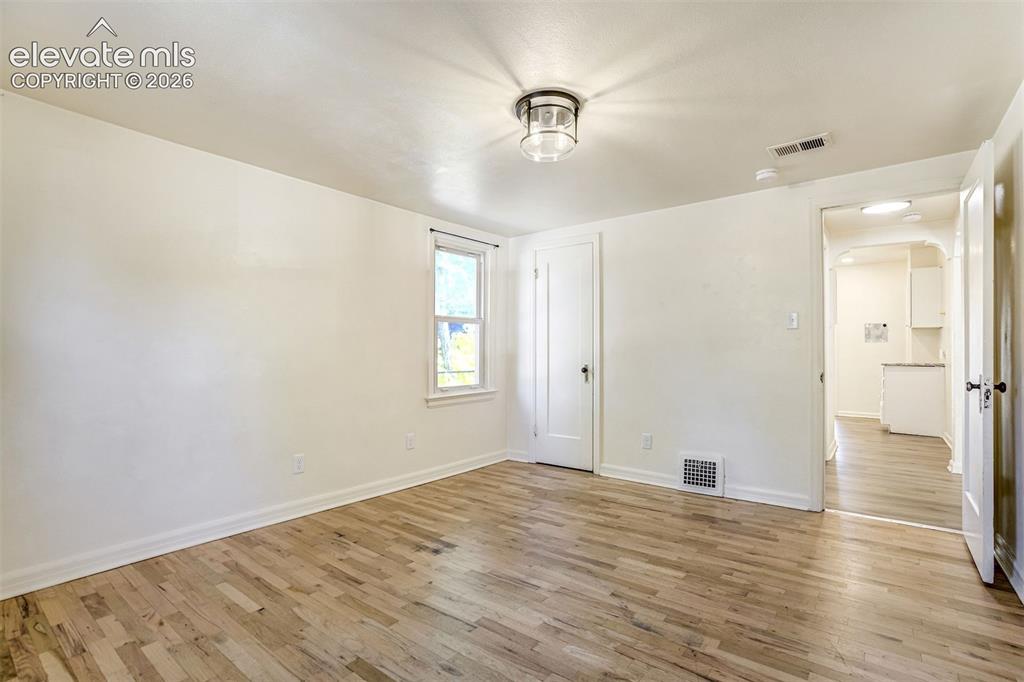 Image 15 of 50: Neutral-toned interior featuring wood-finish flooring, a flush-mount circul