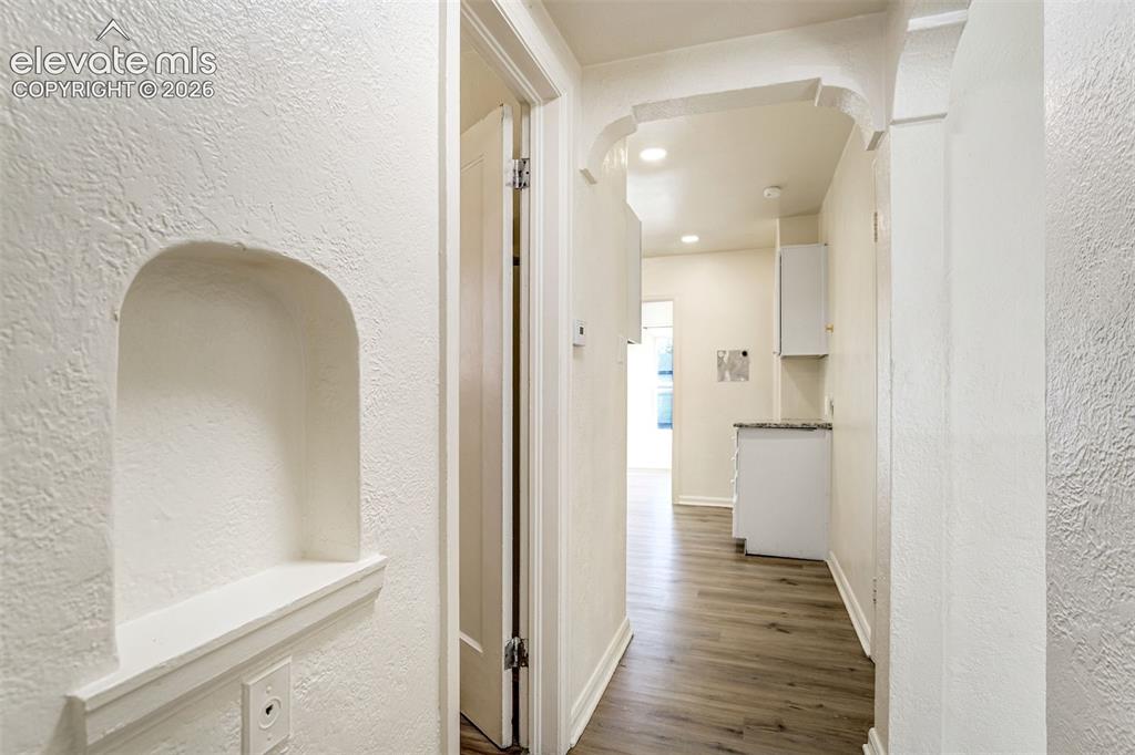 Image 29 of 50: Interior corridor featuring an arched wall niche, recessed ceiling lighting