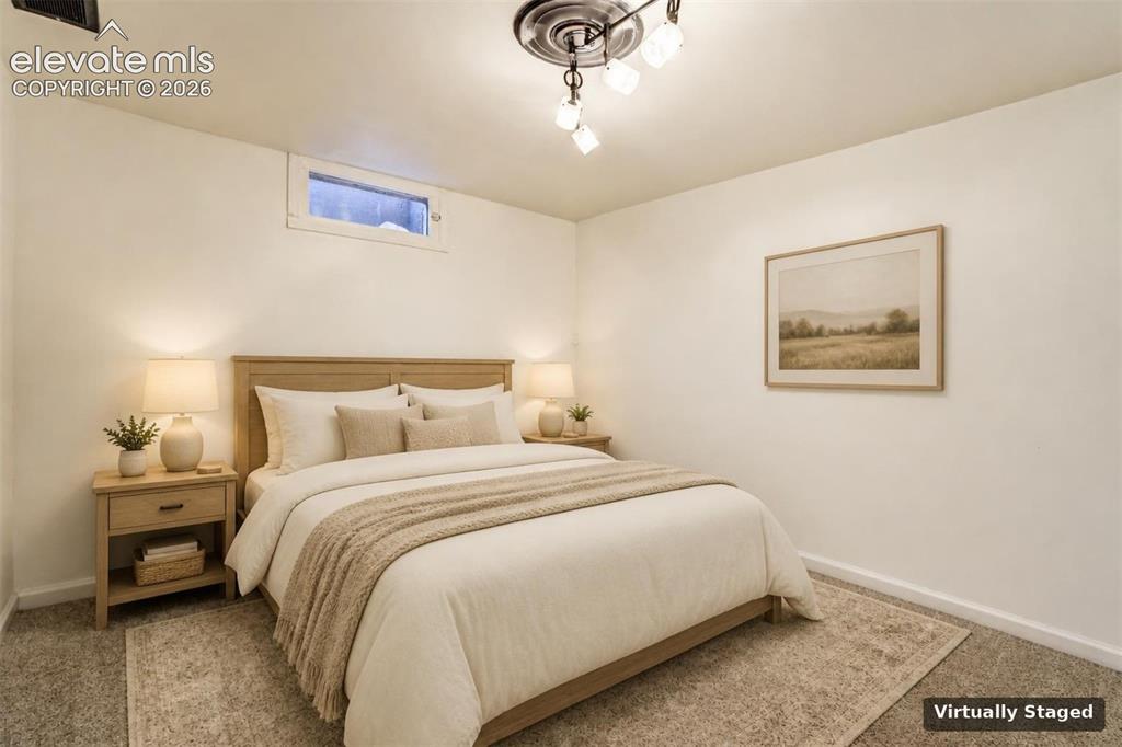Image 42 of 50: Interior room featuring neutral-toned carpeting, ceiling-mounted multi-ligh