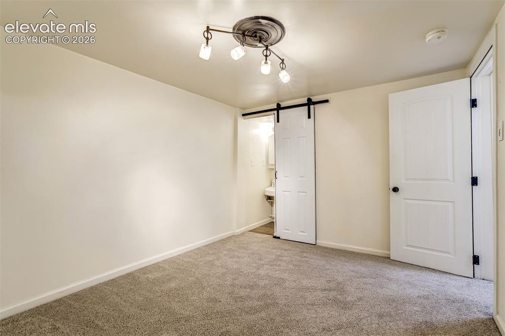 Image 46 of 50: Interior space featuring wall-to-wall carpeting, a multi-light track fixtur
