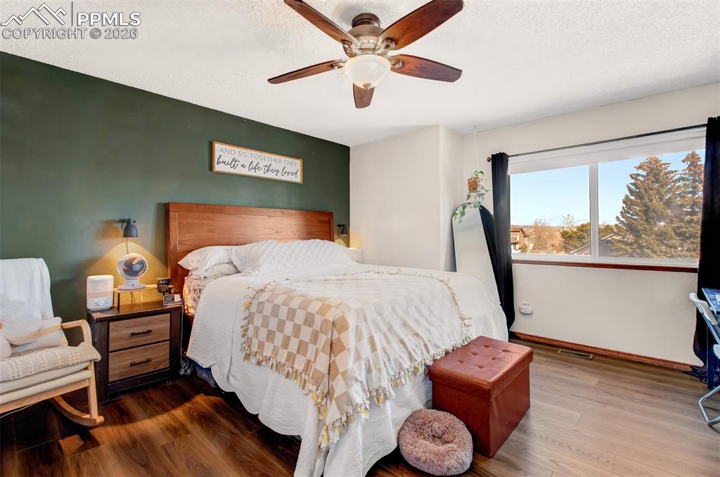 Image 10 of 35: Upper level primary bedroom has great space and overlooks the front of the