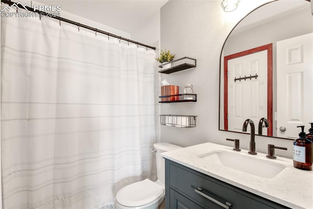 Image 12 of 35: Full primary bathroom with quartz vanity and tub/shower combo