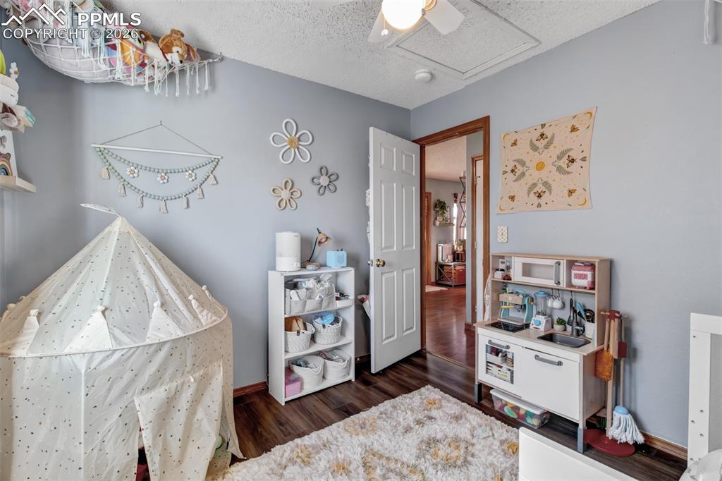 Image 14 of 35: The second upper level bedroom also offers attic access