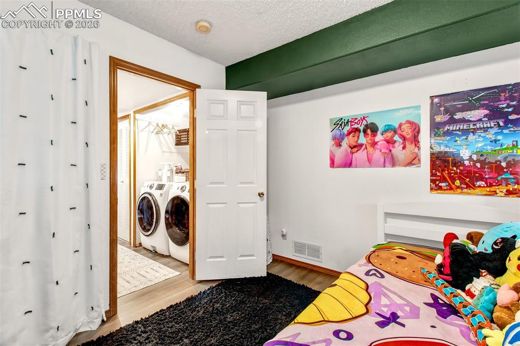 Image 18 of 35: Lower level bedroom offers a seperate quiet living space for family, guest