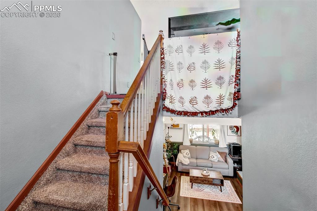 Image 2 of 35: Carpeted stairs lead to the upper level main living area and the lower fami