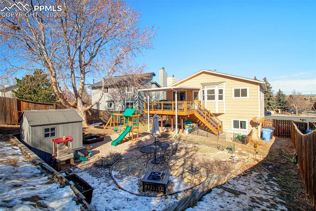 Image 24 of 35: Large fenced backyard with storage shed is slightly sloped to add more priv