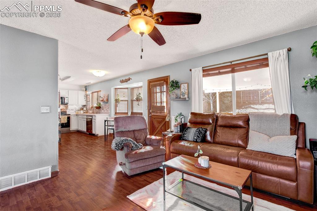 Image 5 of 35: The living room connects to the dining and kitchen spaces giving you an ope