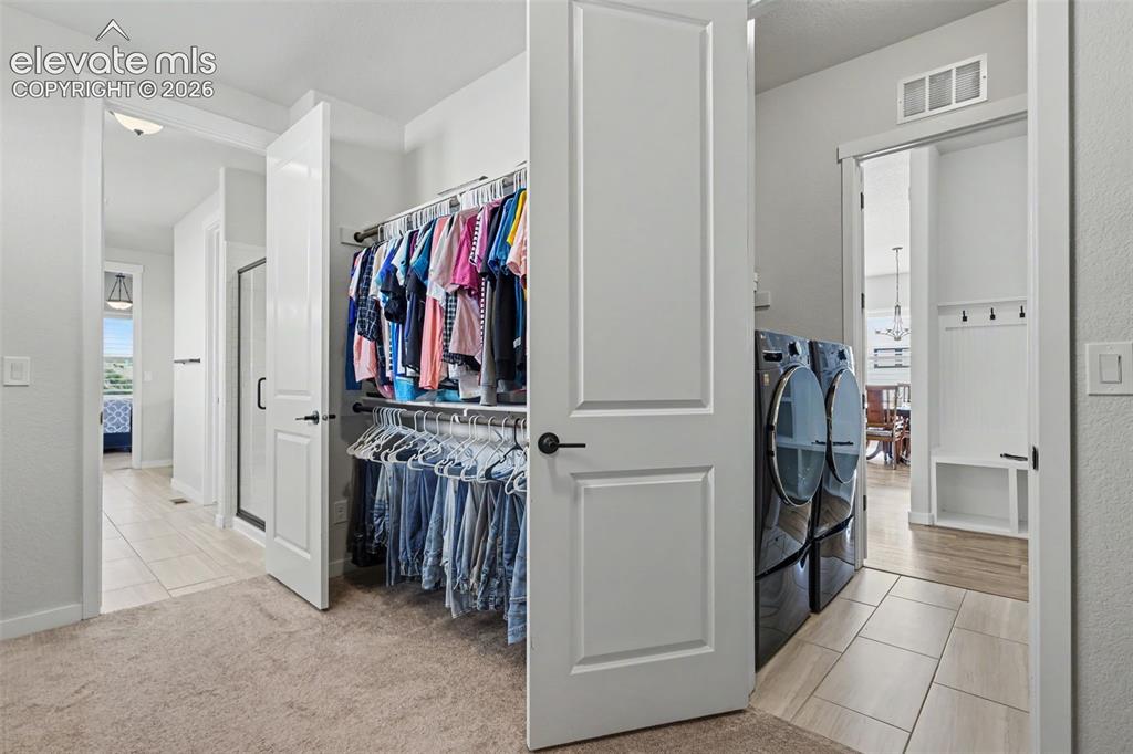 Image 27 of 42: Master closet next to laundry
