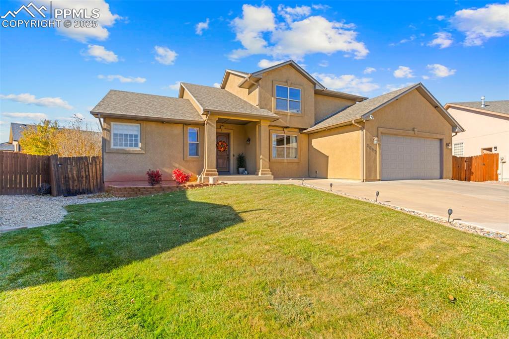Image 2 of 41: Traditional home with stucco siding, a shingled roof, covered porch, and co