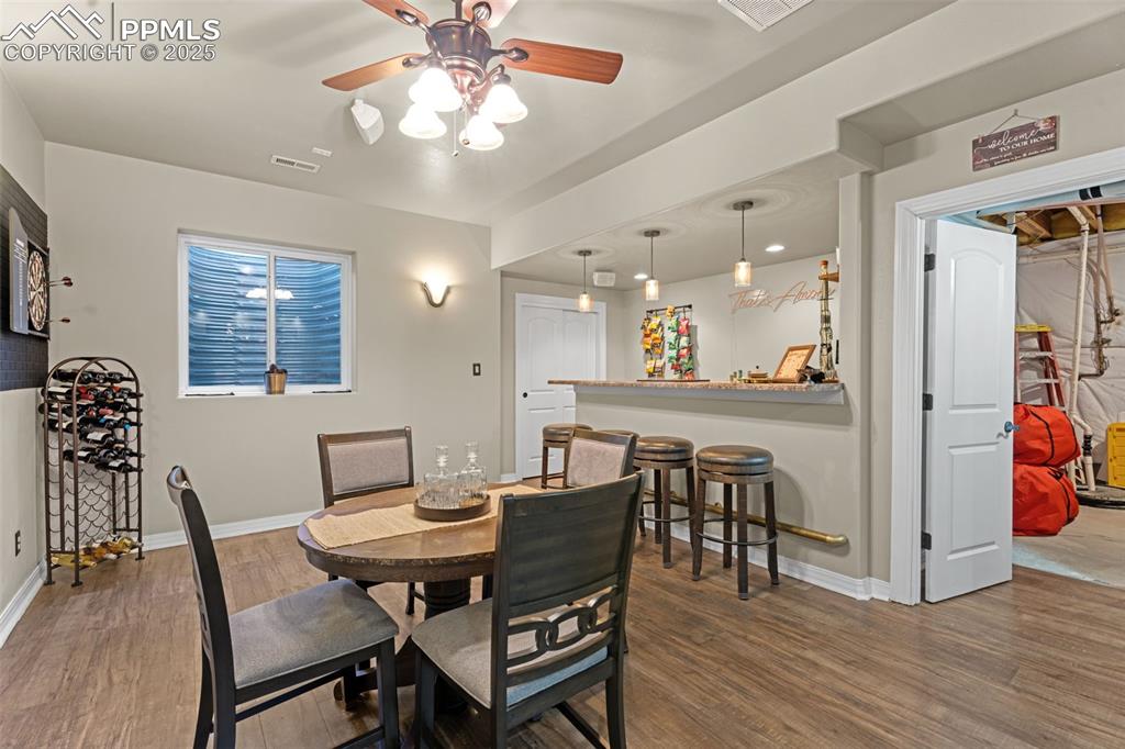 Image 26 of 41: Dining room featuring wood finished floors and a ceiling fan