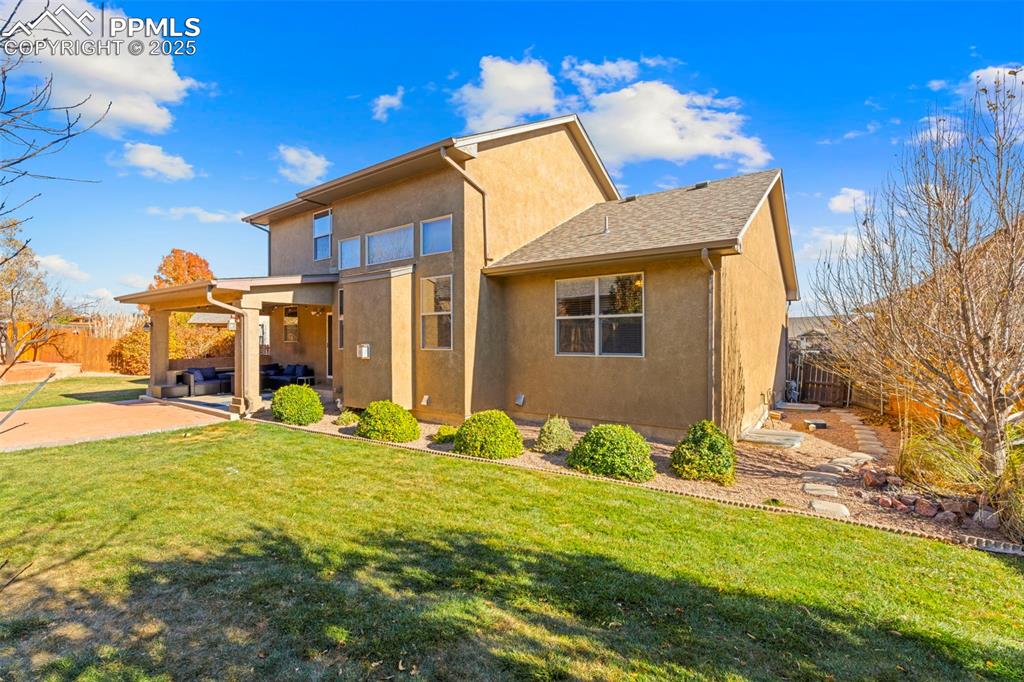 Image 32 of 41: Back of house with stucco siding and a patio