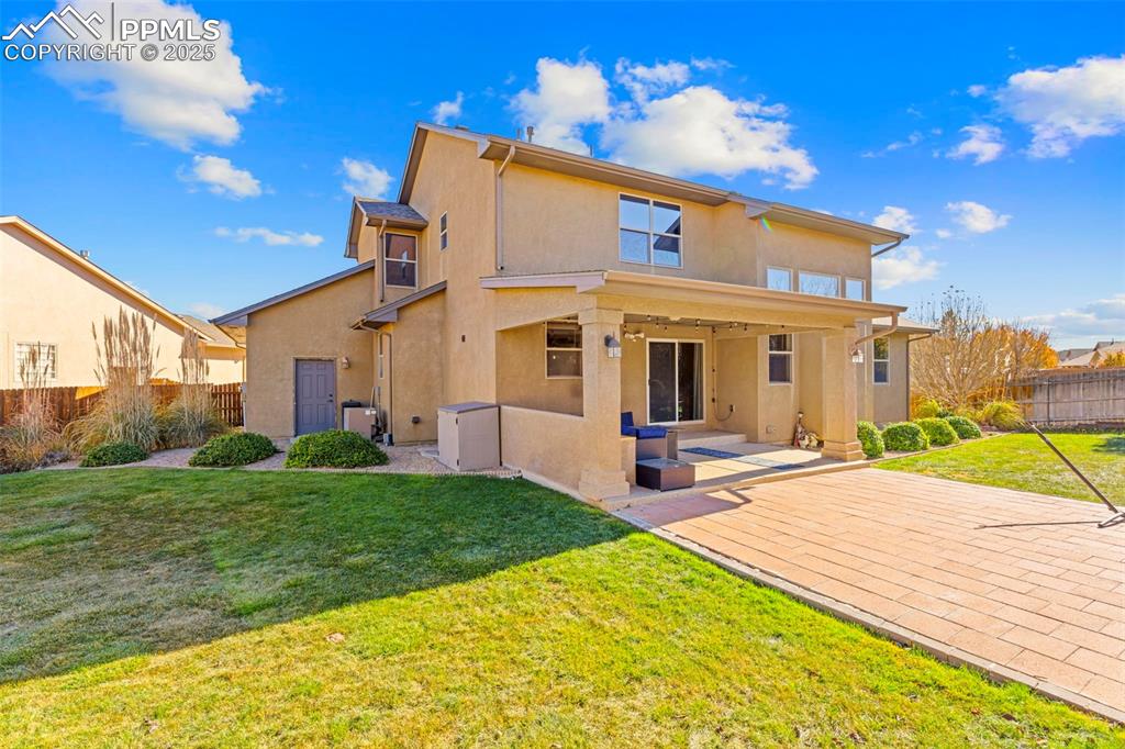Image 33 of 41: Back of house featuring a fenced backyard, stucco siding, and a patio area