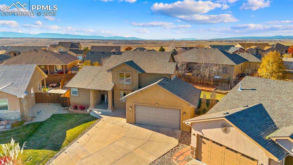 Image 36 of 41: Aerial view of residential area featuring mountains