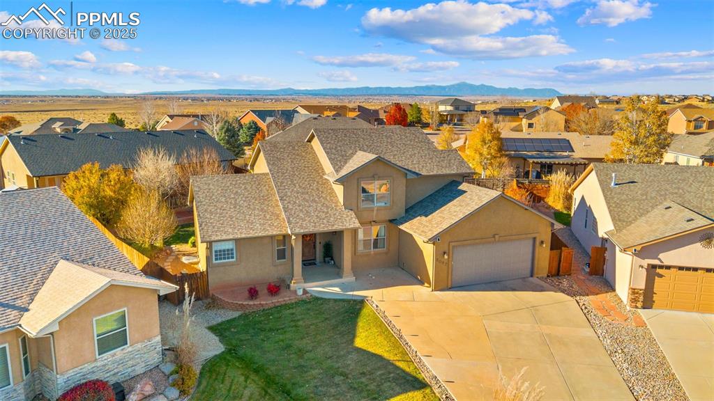 Image 37 of 41: Aerial view of residential area with a mountainous background