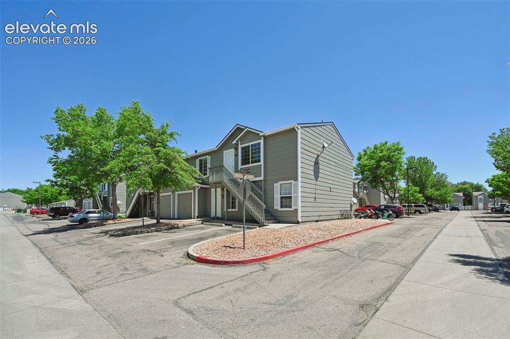 Image 1 of 27: Multi-story residential building with light gray siding and white trim