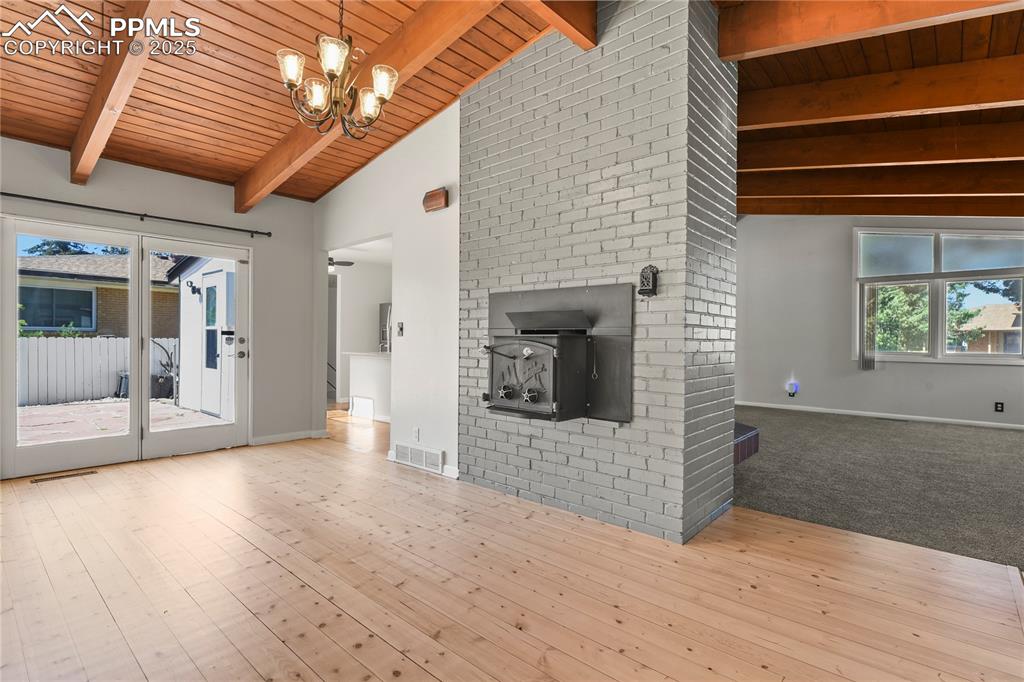 Image 17 of 38: With hardwood floors and wood stove
