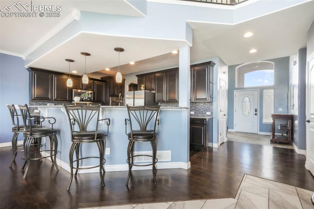 Image 10 of 50: Kitchen with granite counters, stainless steel appliances, large walk in pa